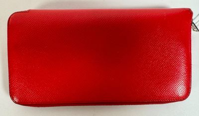 a red purse on a white surface