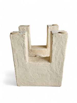 a small cement sculpture of a castle on a white background