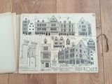 a picture of a book with a drawing of a town on it