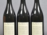 three bottles of wine sitting next to each other on top of a table