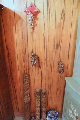 wooden paneled wall in a bathroom with vases on the floor