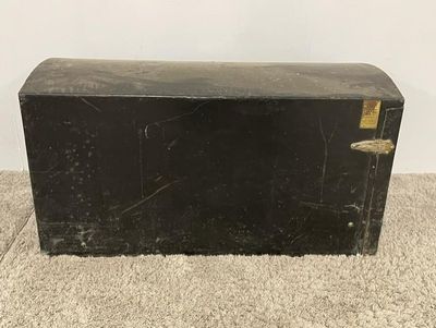 a black box sitting on the floor on the carpet
