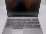 a silver laptop computer sitting on a white surface