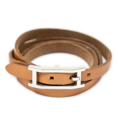 a close up of a brown leather belt with a silver buckle