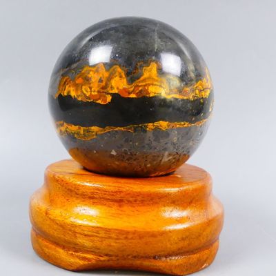 an image of a marble ball sitting on top of a wooden stand
