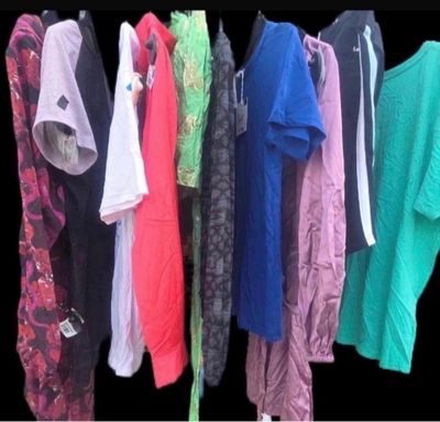 a lot of clothes that are hanging on a rack