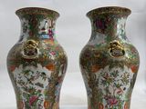 pair of vases sitting on a white surface with a white background