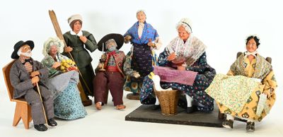 many figurines of people that are sitting on a bench