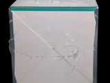a white box with a green lid sitting on a black surface