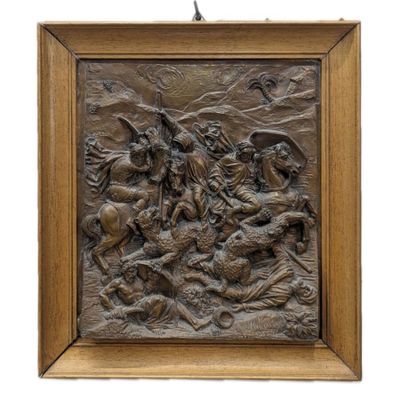 un relief en bronze représentant un homme à cheval dans un paysage