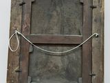 an old wooden picture frame with a rope hanging from it ' s side