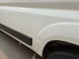 a white truck parked in a parking lot next to a building