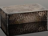 a silver box sitting on top of a black table