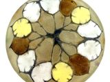 a picture of a round glass object with a flower design on it