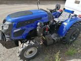 a blue tractor that is parked next to a trailer