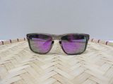 purple mirrored sunglasses on a woven tray on a table