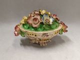 a small bowl with flowers in it on a table