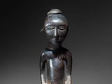 a statue of a woman with a hat on her head