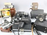 a lot of old cameras on a white table