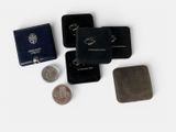 four different types of wallets and a coin on the table