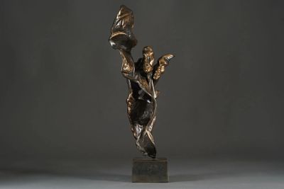 bronze sculpture of a woman holding a bird on a pedestal