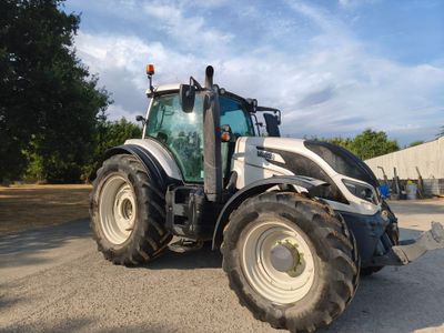 a tractor that is parked on the side of the road