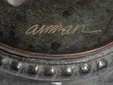 a close up of a silver vase with writing on it