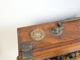 a small wooden box with a clock on top of it
