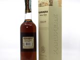 a bottle of karukena whisky next to a cardboard box