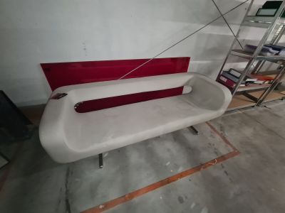 a white and red bench in the middle of a room