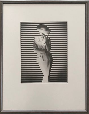 black and white photograph of a woman in a suit and hat