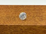 a close up of a diamond sitting on top of a wooden box