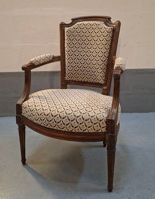 an image of a chair with a patterned upholstered seat in a room