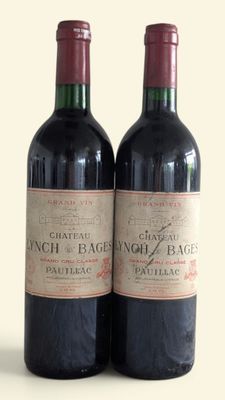 two bottles of wine sitting next to each other on a table