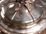 a silver plate with a flower on top of it