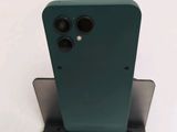 a close up of the back of a green phone on a stand