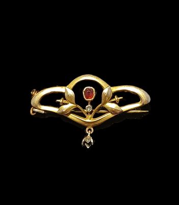 an image of a gold and garnet stone broochle