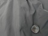 a person wearing a jacket with a button on it
