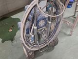 a bike with a hose attached to it in a garage