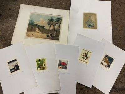 several prints of different types of art are on a table