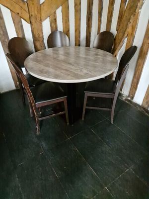 une table et des chaises dans une pièce aux murs en bois