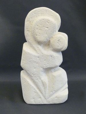 an image of a white stone sculpture of a woman holding a child
