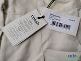 a label on the back of a pants that is on a hanger