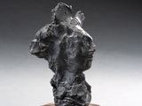 an image of a sculpture on a wooden stand