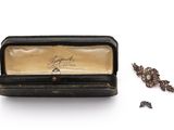 a box with a ring inside of it and a pair of earrings