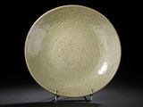an image of a green plate on a stand against a black background