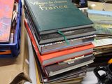 a pile of books sitting on a table next to a pair of scissors