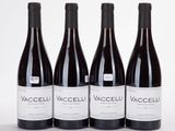 three bottles of red wine are lined up on a white surface