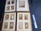a lot of old photos in a book on the table