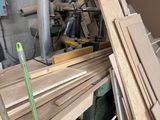 many pieces of wood stacked up in a room